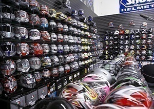 Rows of helmets line the walls of the dealership showroom.