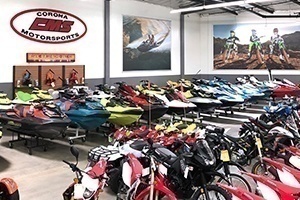 A row of red and white motorcycles line the showroom floor.