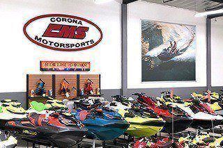 The showroom features brightly colored watercraft.
