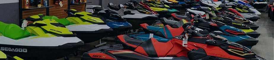 Brightly colored personal watercraft line the showroom.